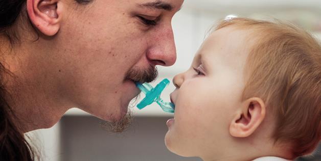 Sucking on your kid's pacifier